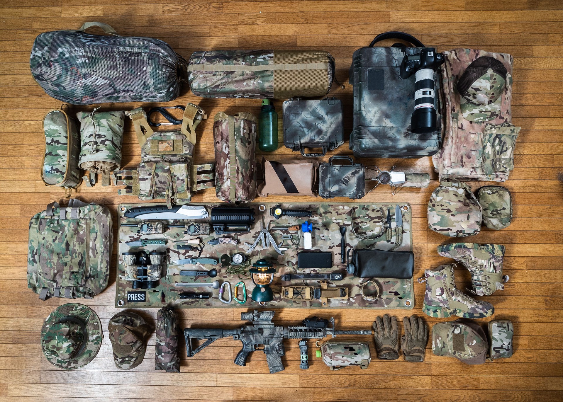 Multicam camouflage military themed camping/bugout bag gear flat lay
