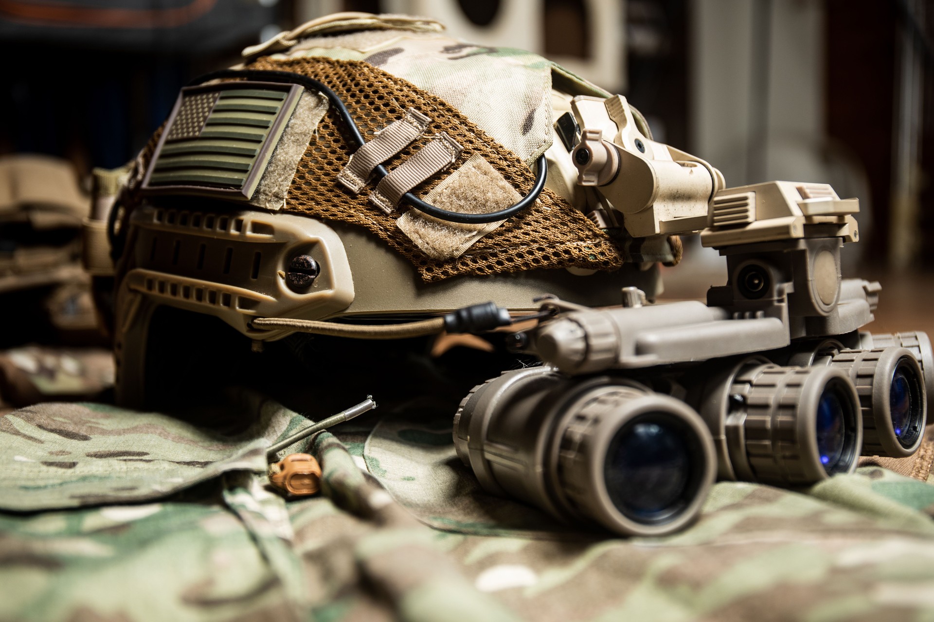 Tactical FAST helmet with US flag,  night vision goggles and multicam background