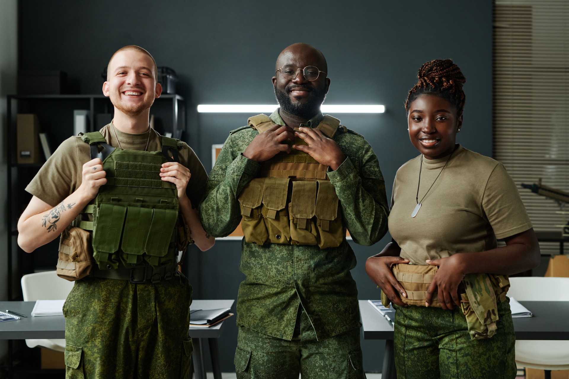Happy young intercultural men and woman in bulletproof vests